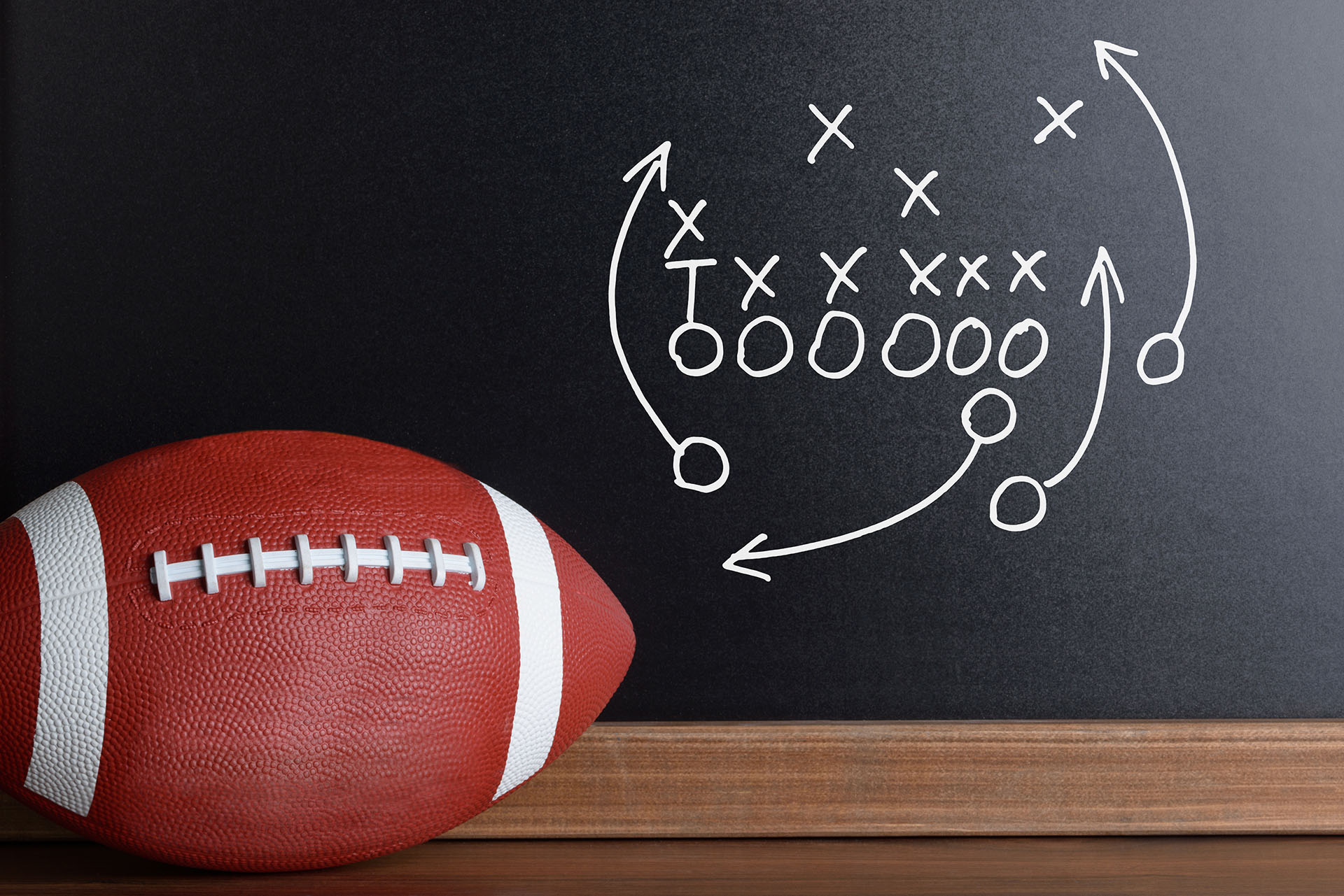 Football and chalkboard depicting hotel strategy