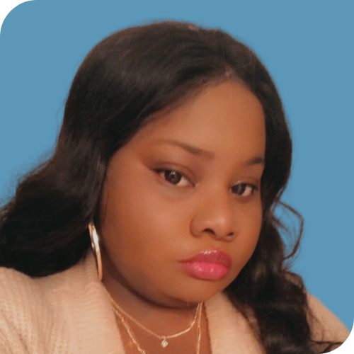 A woman wearing a blazer and pink earrings.